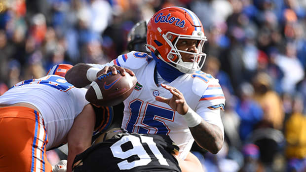 Florida Gators quarterback Anthony Richardson throws an interception as he is pressured by Vanderbilt Commodores defensive end Darren Agu and defensive lineman Christian James.